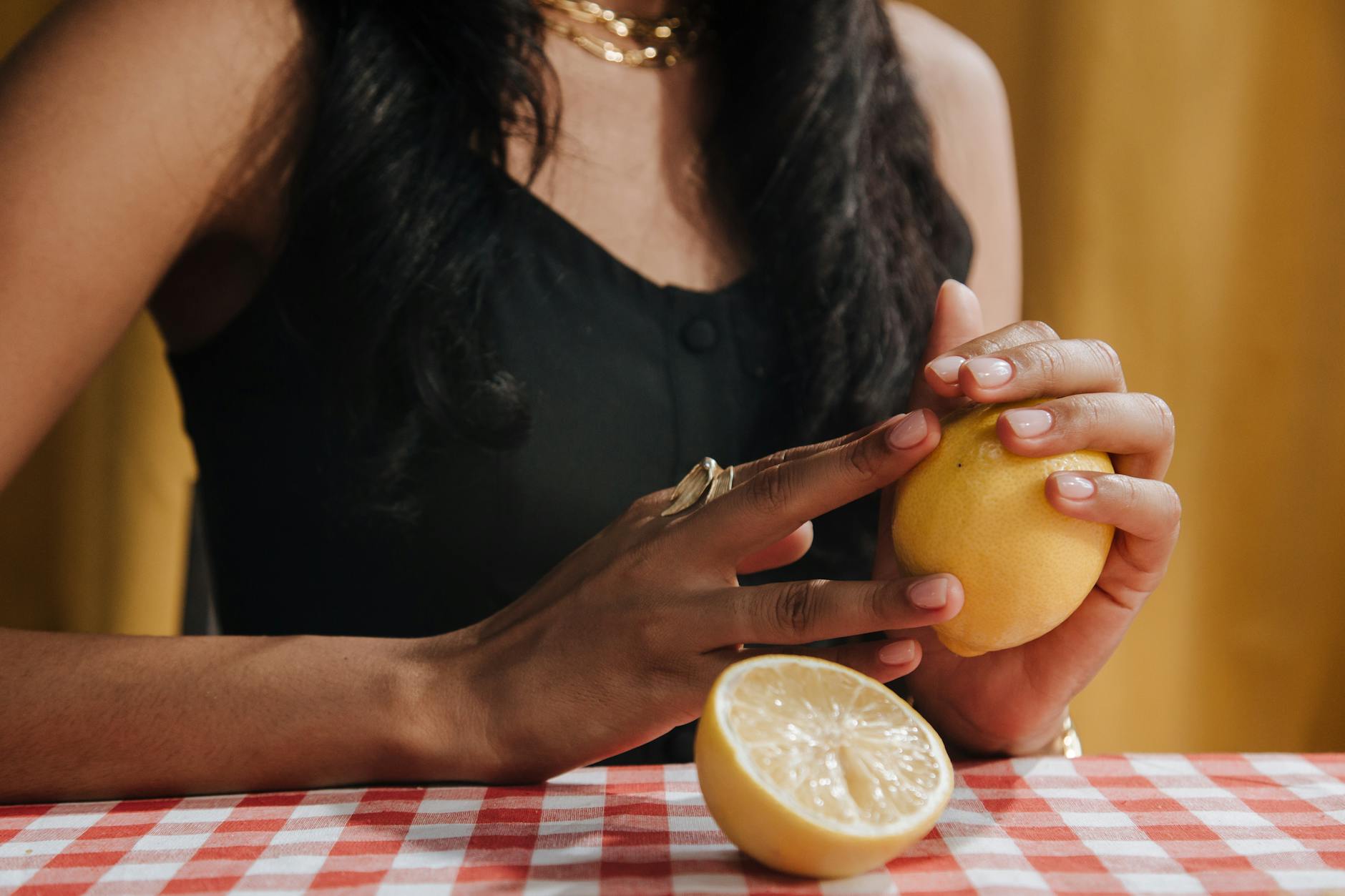 Close-up of hands holding a sleek vibrator against a purple background, symbolizing reclaimed self-intimacy